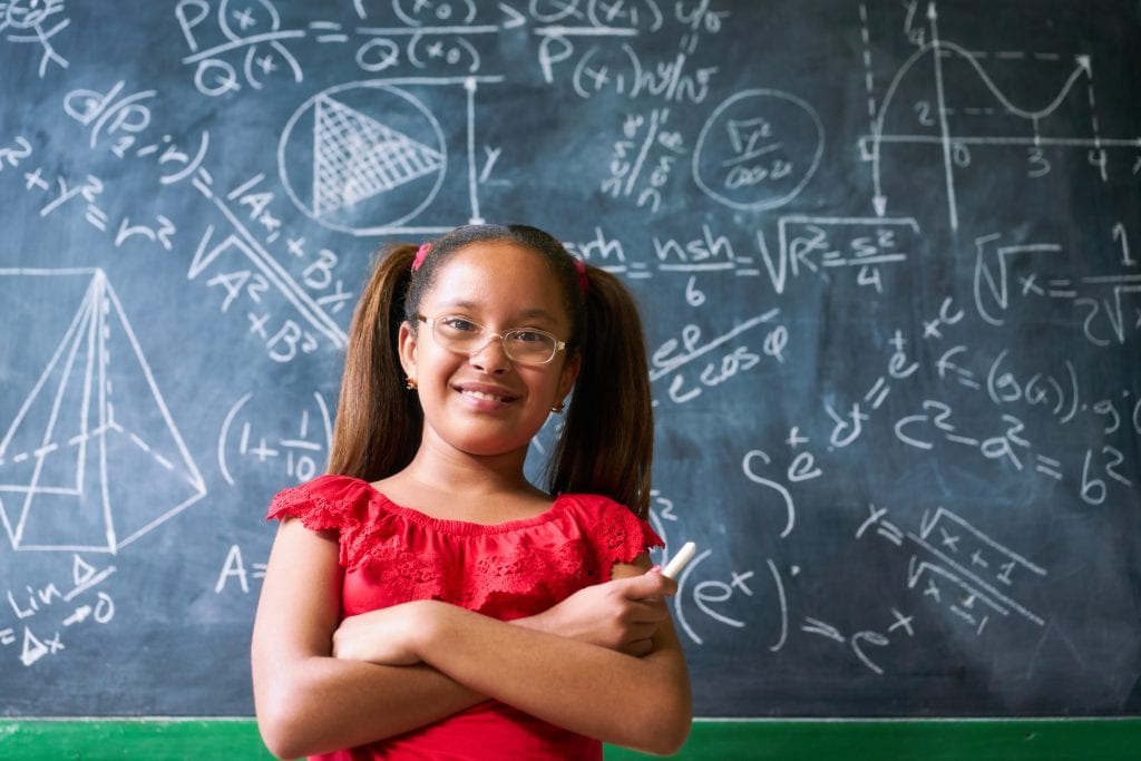 Portrait Happy Girl Resolving Complex Math Problem On Blackboard